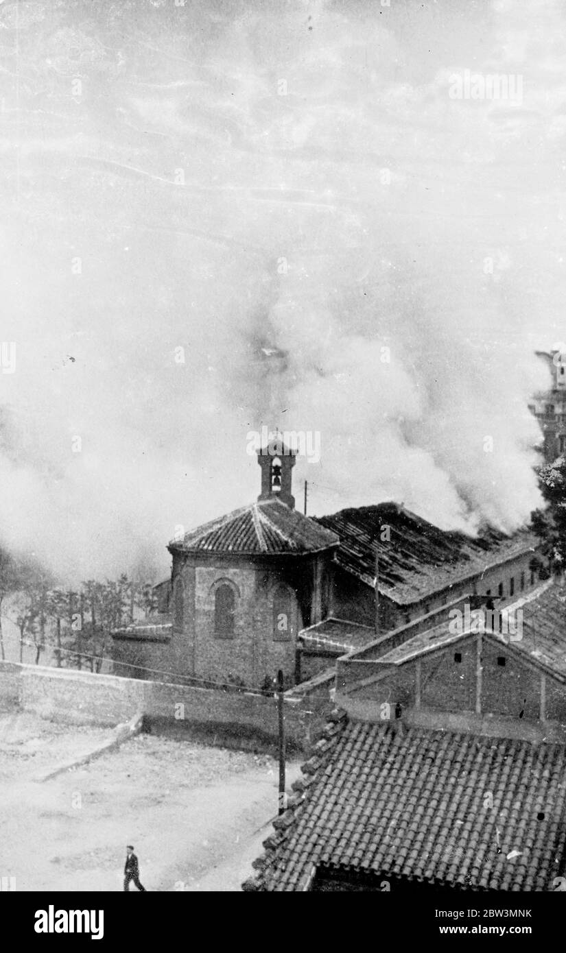 Anarchists fire churches and schools in Madrid . Churches , schools and other buildings as well as motor cars in the streets were set on fire by anarchist mobs , who broke loose in Madrid and defied the efforts of the civil guards and troops to hold them in check . The anarchists alleged that a child had poisened with sweets , which was denied by the authorities and gave this as the pretext for the new reign of terror . Photo shows , the church and schools of Ave Maria blazing furiously in Madrid after having been set alight by anarchists . 7 May 1936 Stock Photo