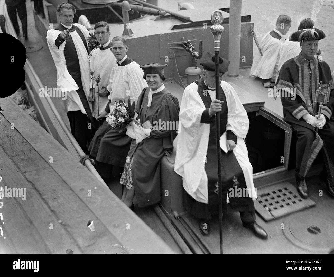 Beating bounds of St Dunstan ' s in East Church was carried out . A tug was used to take the party into the middle of the Thames at Tower Pier when the ceremony of Beating the Bounds of St Dunstan ' s in the East Church was carried out . Photo shows the ceremony aboard the tug . 25 May 1936 Stock Photo