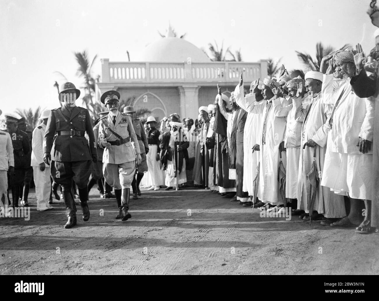 Badoglio takes over Italian command from De Bono . Native leaders of Massawa saluting Marshal Badoglio ( left ) and Marhsal de Bono on their arrival at the Governor 's Palace . 6 December 1935 Stock Photo