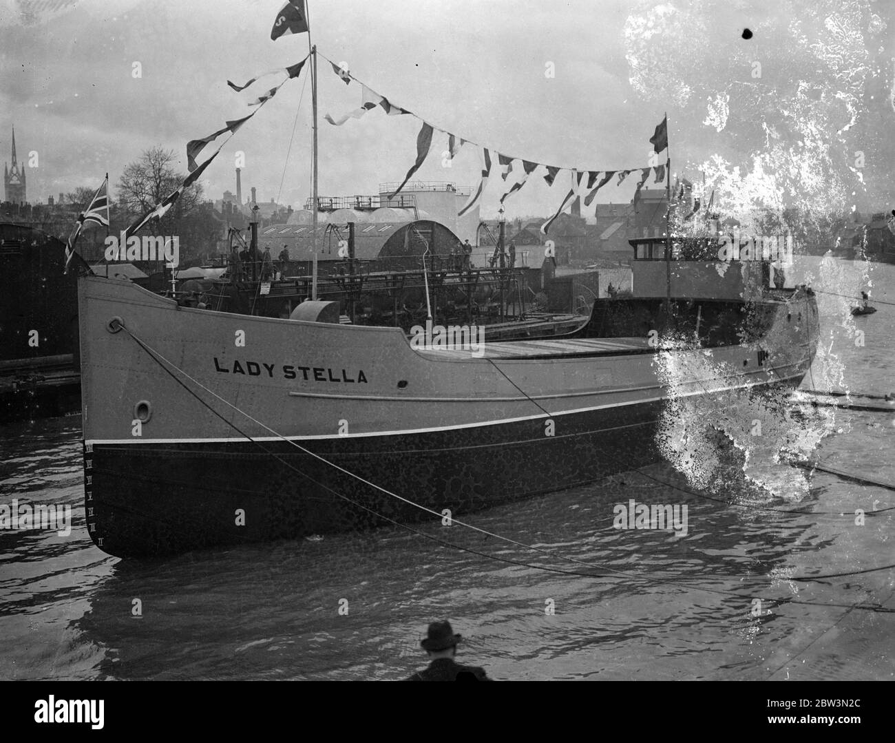 260 ton motor ship launched broadside at Faversham . The Lady Stalls , a 260 ton cargo capacity motor coaster , was launched broadside into a creek at Faversham , Kent . The shipbulding yard of Messrs . James Pollock , Sons and Co , ltd , is one of the few remainig shipyards of Britain where the broadside metho of launcing still prevails . Photo shows , the Lady Stella taking the water broadside with a mighty splash . 30 November 1935 Stock Photo