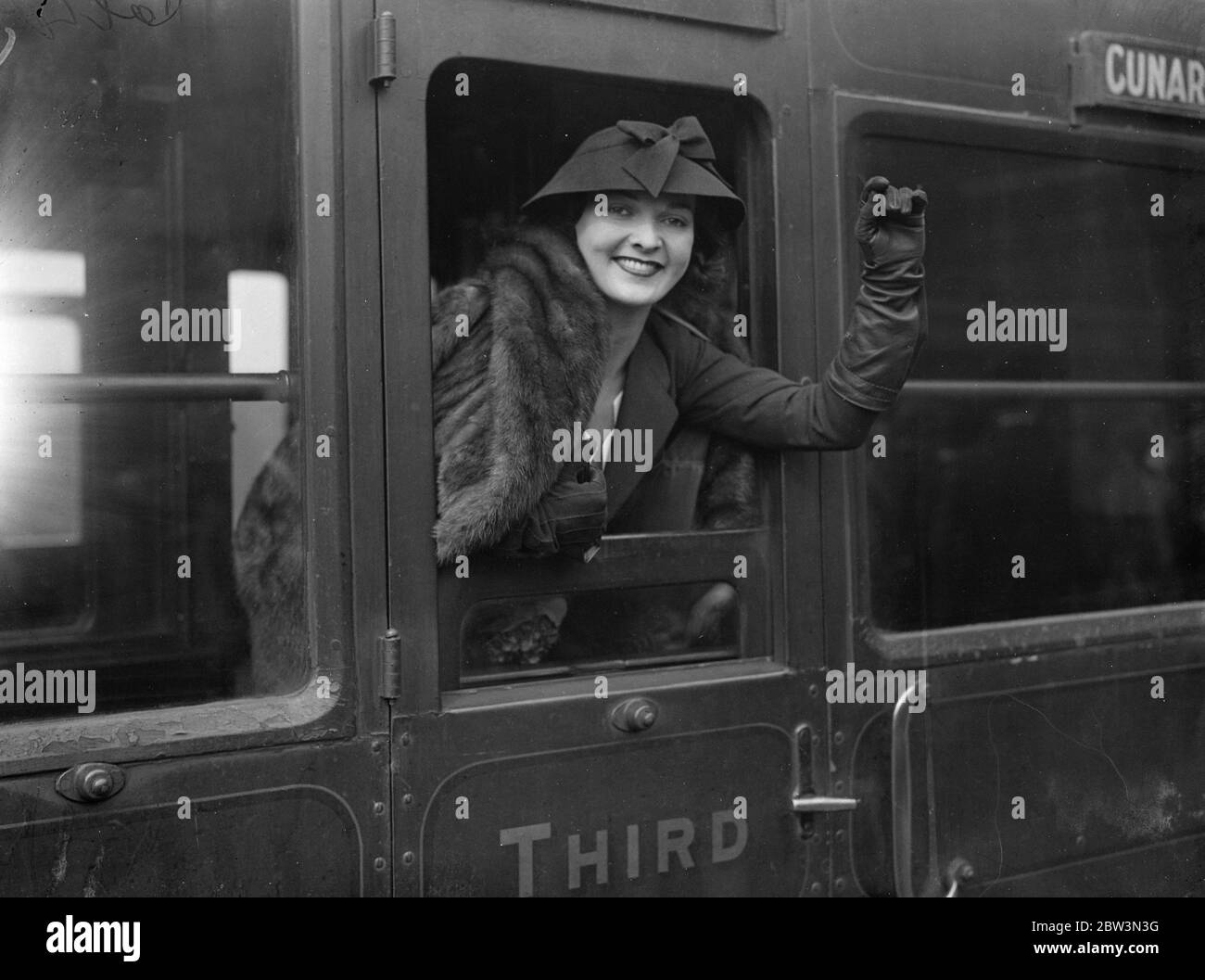 Gina Malo leaves for holiday in America . Gina Malo in her carriage window at Waterloo . 19 March 1935 Stock Photo