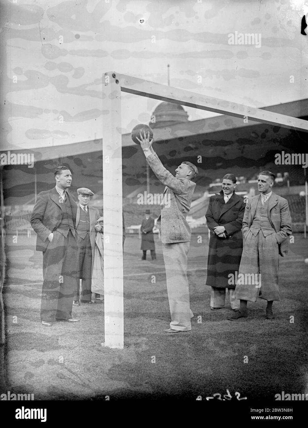 Sheffield United inspect cup final pitch at Wembley . The Sheffield United team which is to meet Arsenal in the FA Cup Final tomorrow ( Saturday ) inspected the pitch at Wembley Stadium . Photo shows , Jack Smith , the Sheffield goalkeeper , testing the height of the goalposts . 24 April 1936 Stock Photo