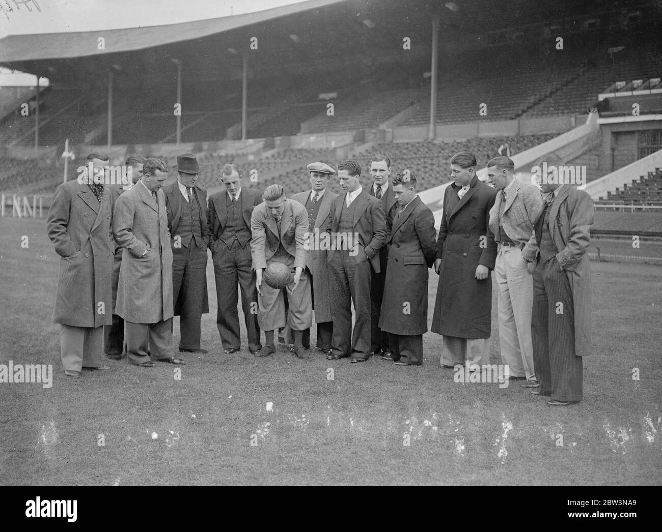 Sheffield United inspect cup final pitch at Wembley . The Sheffield United team which is to meet Arsenal in the FA Cup Final tomorrow ( Saturday ) inspected the pitch at Wembley Stadium . Photo shows , Harry Hooper , the Sheffield United captain , bouncing a ball to test the ground , watched by the rest of the team . 24 April 1936 Stock Photo
