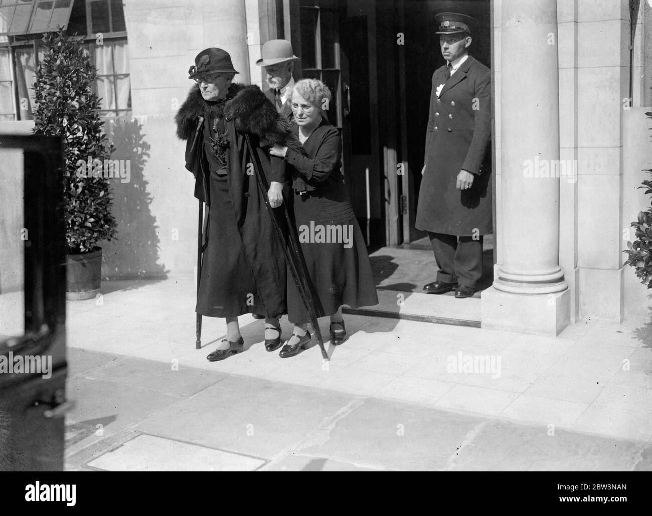Peer of 82 weds sister in law of 81 at London Register Office . Lord Monteagle married Mrs Julia Spring Rice at Kensington Register Office . The bride being assisted from the house followed by the bridegroom as they left the register office . 11 September 1935 Stock Photo