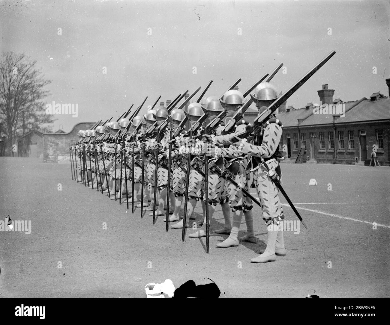 Norfolk regiment ' Musketeers ' rehearse for Royal Tournament . The 2nd Battalion , the Royal Norfolk Regiment , held a full rehearsal at Aldershot for the pageant which will be a feature of the Royal Tournament at Olympia . Photo shows , ' Musketeers ' of the Elizabethan period drilling . 30 April 1936 . Stock Photo
