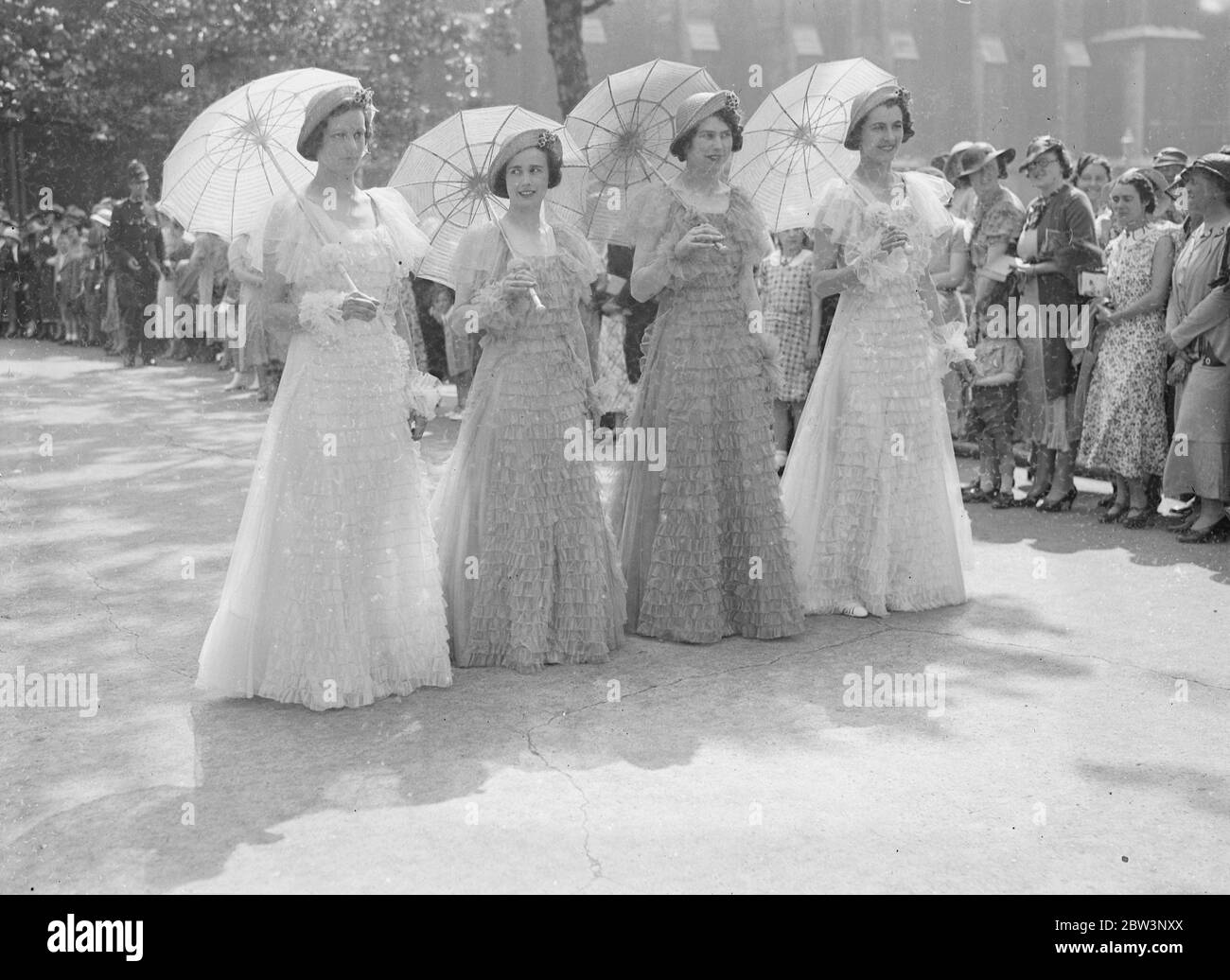 With the bridesmaids carrying parasoles the wedding took place at St Margaret ' s , Church , Westminster , of Captain J L Cecil Williams , honorary secretary of the Society of Cymmrodorion , and Miss Clive Williams of Denbigh . Part of the service was in Welsh , and there was an orchestra of three harpists dressed in the national Welsh dress . 22 June 1935 Stock Photo