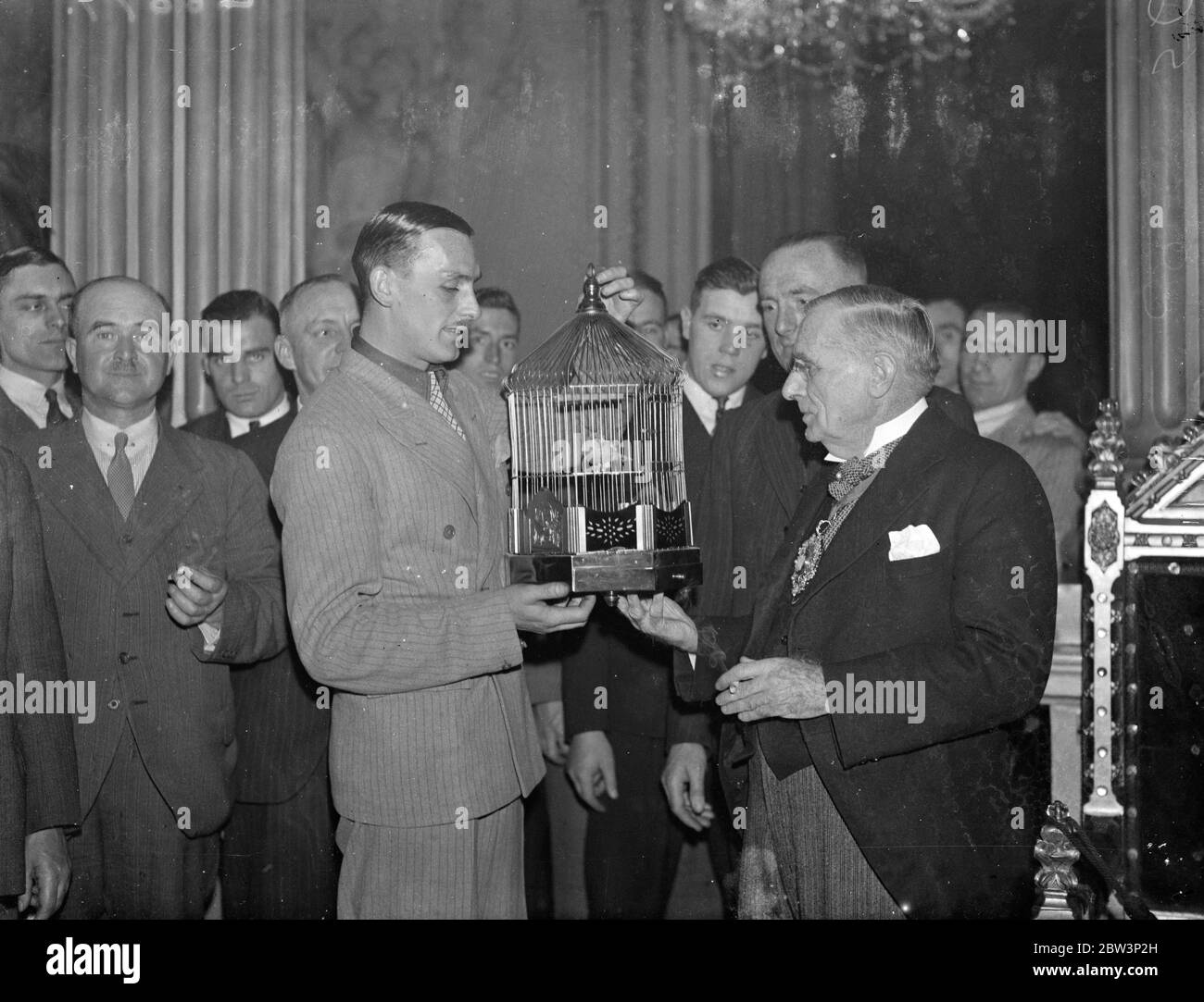 Norwich footballers present canary to the Lord Mayor . The Norwich City football team who are to meet Tottenham Hotspur tomorrow ( Saturday ) , were received by the Lord Mayor , Sir Percy Vincent , at the Mansion House , when they had tea with the Lord Mayor and presened him with a canary . Norwich is famous for its canaries , and the Lord Mayor himself is a Norfolk man . It is expected that Sir Percy will watch tomorrow ' s match . Photo shows , the Lord Mayor ( right ) receiving from Tom Halliday , captain of the Norwich City team , the canary presented to him by the club . 13 December 1935 Stock Photo