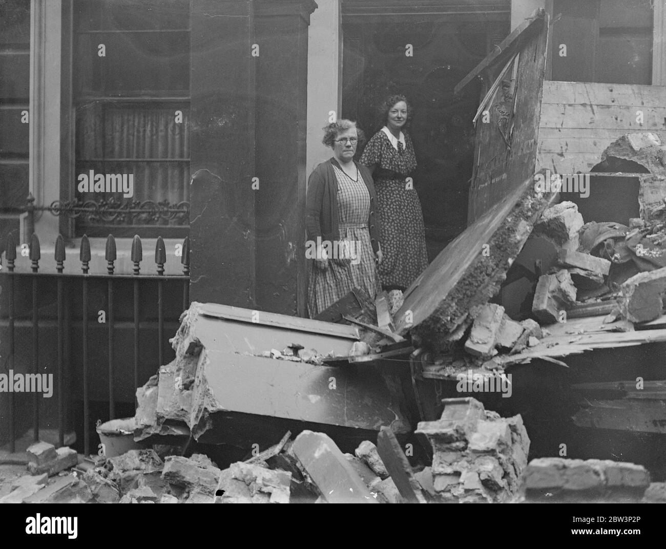 Two women narrowly escape when lorry crashes into house at Millbank , London . Mrs M Calvert and Mrs M E Calvert amid the debris after the crash . 22 November 1935 Stock Photo