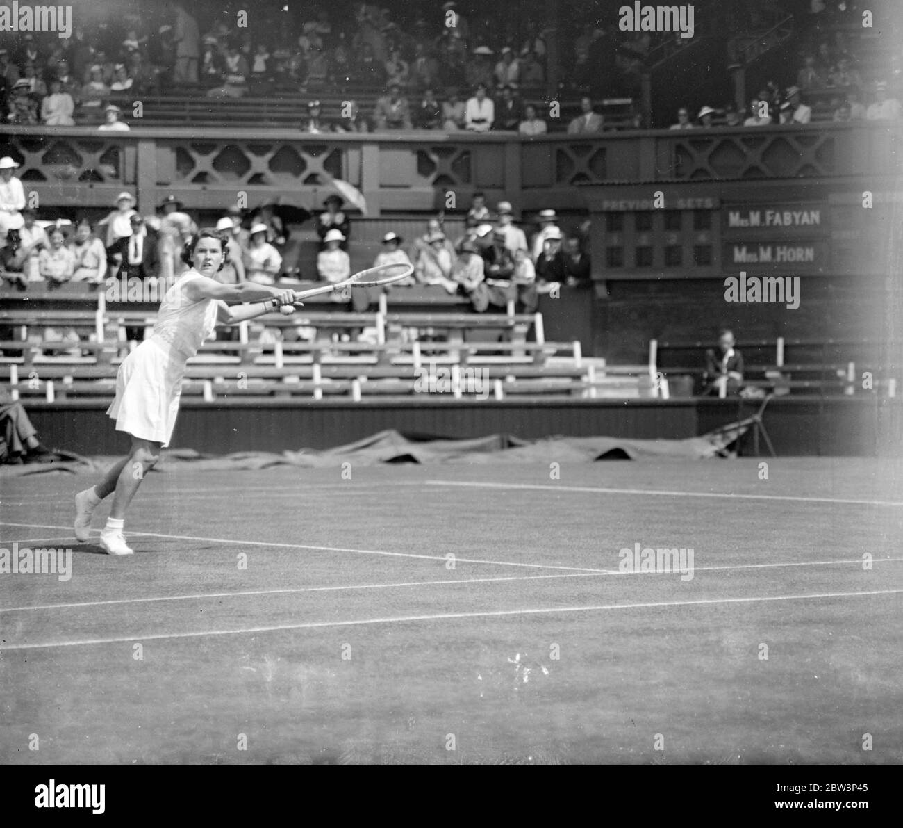 Mrs. Fabyan Meets Fraulein Horn In Women ' s Singles At Wimbledon . This was women ' s day at Wimbledon a number of players of international repute making their appearance in the championship . Photo Shows : Mrs . M . Fabyan ( USA ) in play against Fraulein M . Horn ( Germany ) on the centre court in the first round of the women ' s singles . 23 Jun 1936 Stock Photo