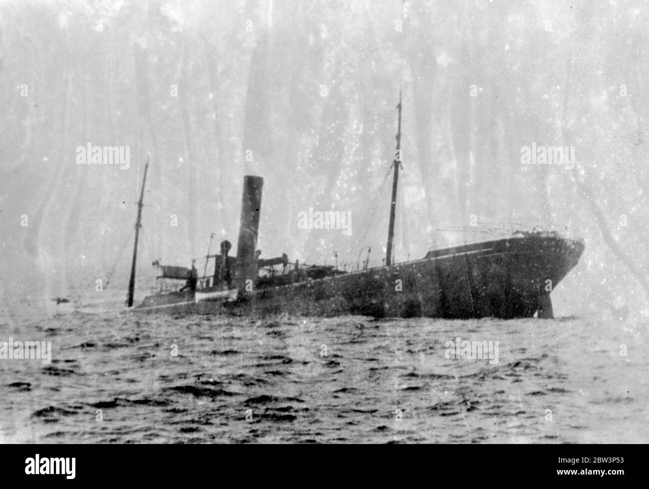 Steamer wrecked in collision , crew rescued . The Greek cargo ship Katingo was wrecked off the French coast near Brest after a collision with the Italian ship Assunzione . The crew of the Katingo were rescued . Photo shows , the sinking Katingo after the collision . 8 May 1936 Stock Photo