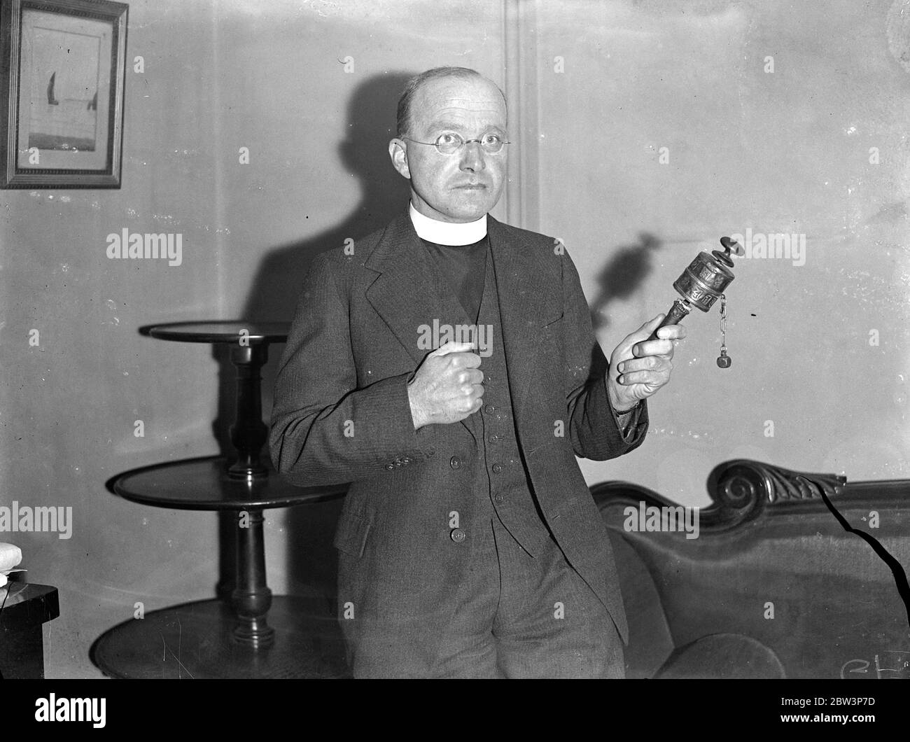 Missionary who has made two converts in 14 years home from icy wastes of Tibet . The Rev Walter Asboe photographed in London with a Tibetan Buddhist praying wheel . The prayers are placed inside and the wheel is then swung round . 7 December 1935 Stock Photo