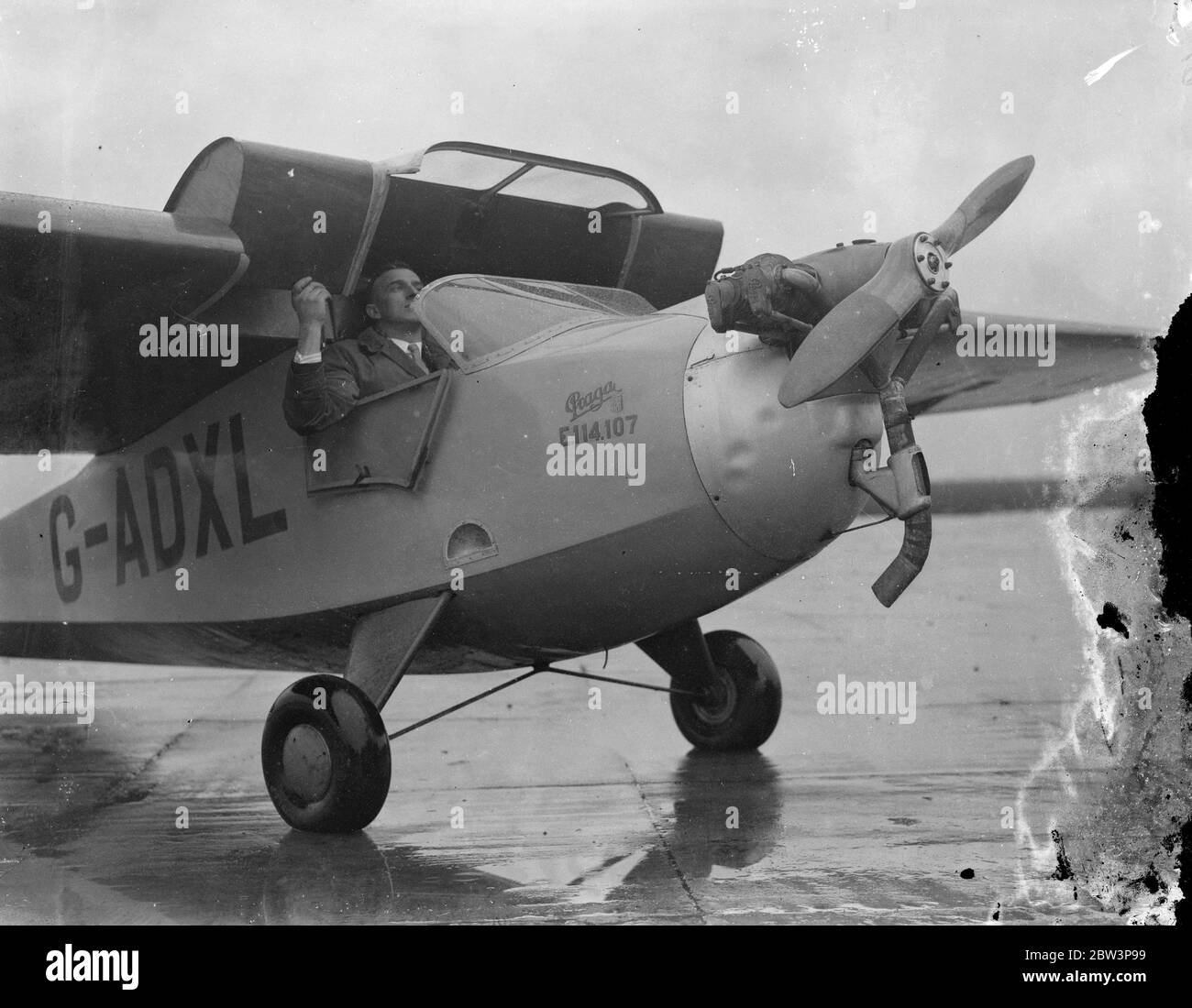 New sporting baby planes undergo first tests at Heston . The Hillson Prags , a new light sporting two seater designed to meet the requirements of wide sporting circles regarding low selling prices and servce expenses , underwent its first tests at Heston Aerodrome . the machine , a light hig wing monoplane , and side by side cabin seating for two people . The wing , which is fixed on the fueslage by four bolts entirely covers the cockpit , but can be detached by a crew of two within five minutes , rendering complicated wing folding unnecessary . The new baby plane powered by a Praga ' B ' 40 h Stock Photo