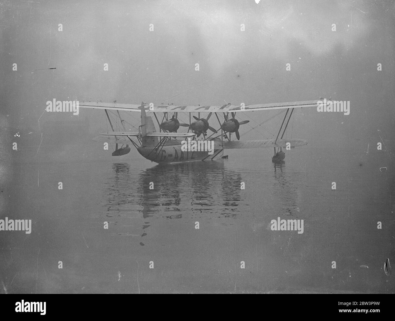 Following the decision approving the start of Atlantic survey flights next year and commencet of an experimental air mail serviceshortly after, Imperial Airways pilots are receiving flying boat instruction at a Hamble , Hampshire , flying school . They receive a certain number of hours preliminery training on the Cutty Sark light amphibion boats and then take over on multi enginerd machines similar to those being used on the Empire routes . Imperial Airways has handed over to the pupils a Short Calcutta flying boat for their training . Photo shows , Imperial Airways pilots receiving instructio Stock Photo