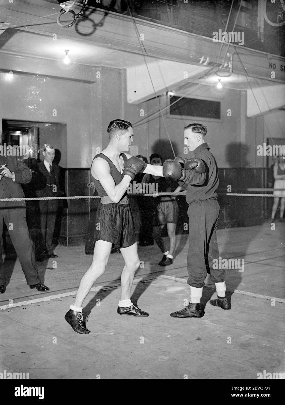 British amateur boxing champions train for ' Golden Gloves Tournament ' . The Amateur boxing champions who are to compose the British team for the ' Golden Gloves ' tournament against the American ' Golden Glovers ' are training at the Polytechnic in London to repeat Britain ' s success of last year when the forthcoming matches are held . The tournament opens at the Empire Pool Wembley , May 5 . Photo shows F J Simpson the British amateur lightweight champion ( left ) sparring with J W Treadaway ( featherweight champion ) . April 1936 Stock Photo