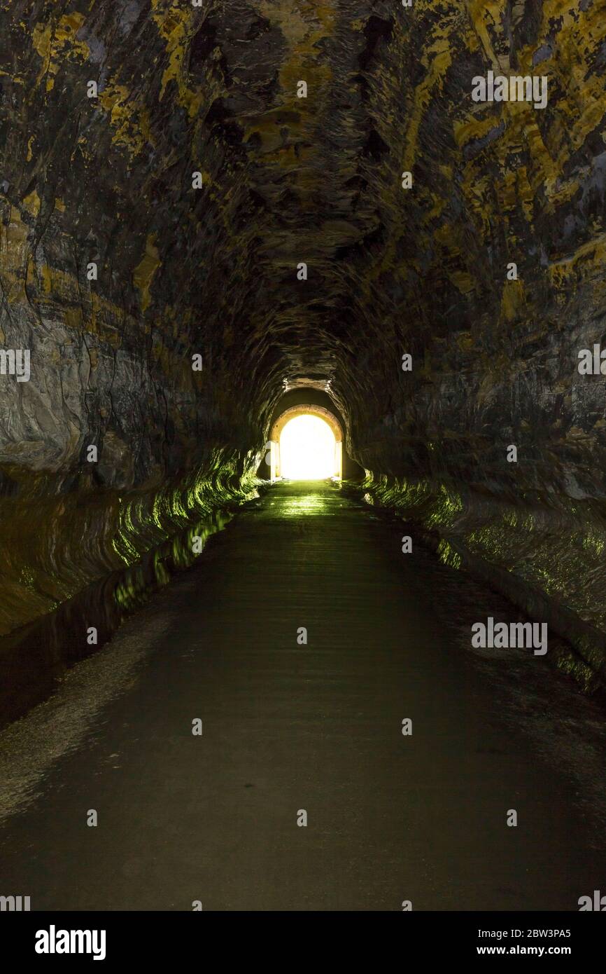 Inside a former railroad tunnel looking towards the light at the end of