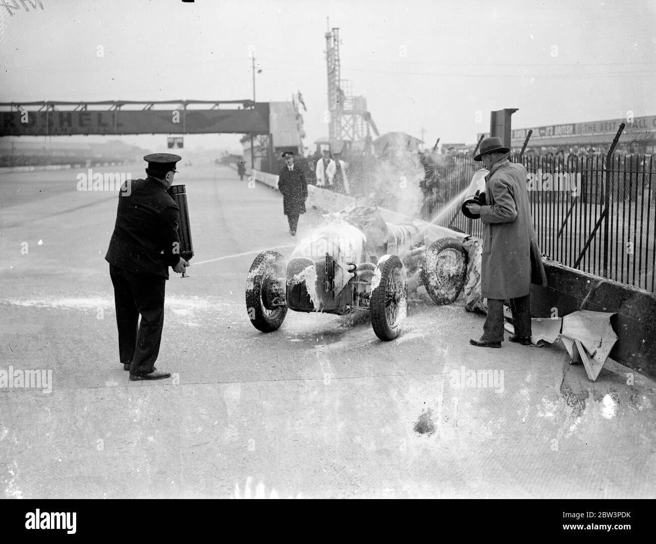Woman driver leaps from blazing car at international trophy race . Miss Doreen Evans had to leap for her life when her M G car caught fire during the international trophy races at Brooklands . Photo shows , Miss Doreen Evans MG burning . 2 May 1936 . Stock Photo