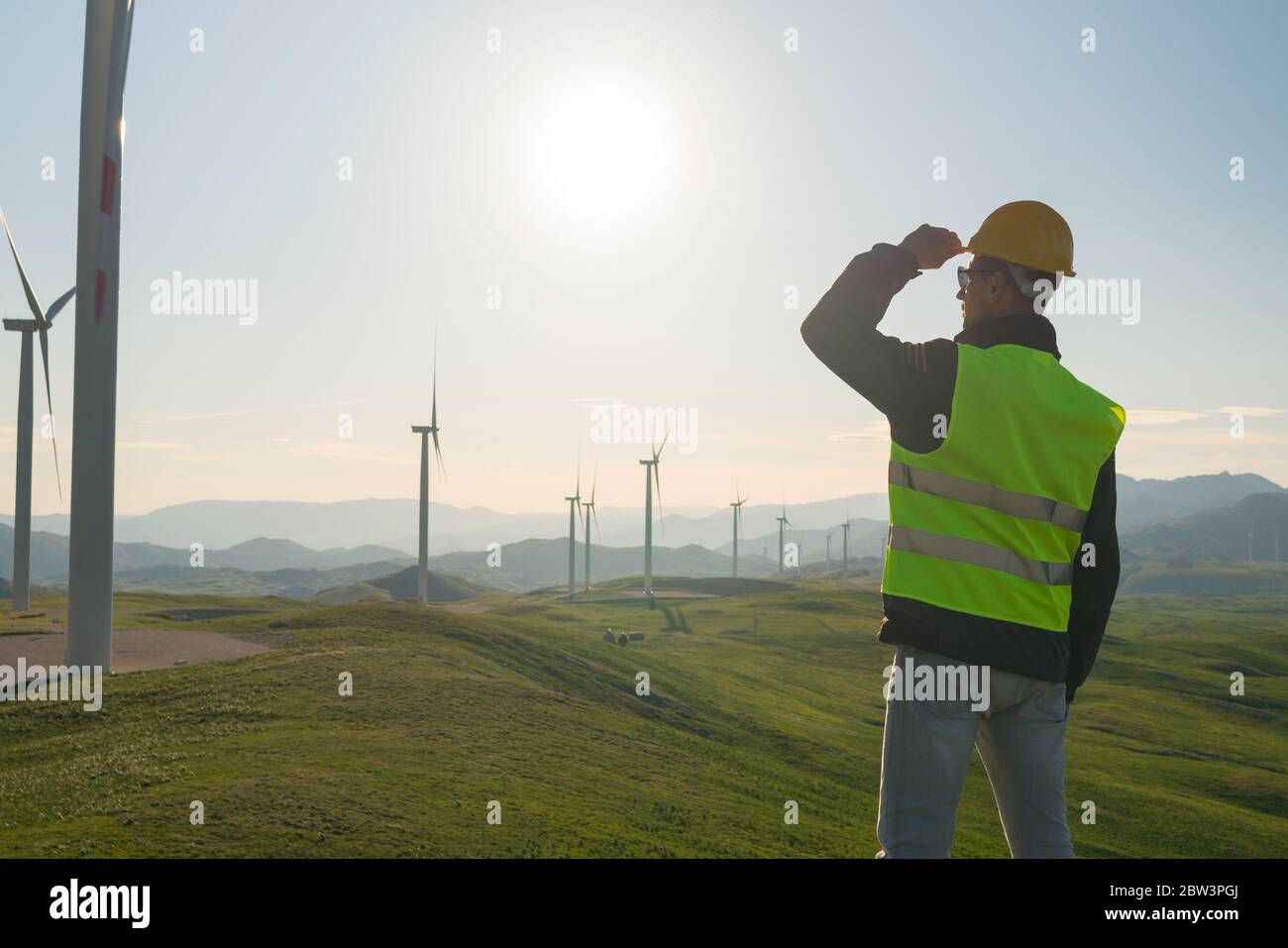 Technician Engineer in Wind Turbine Power Generator Station Stock Photo