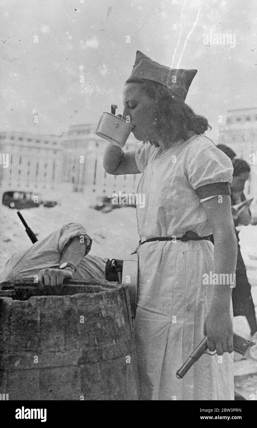 First pictures received by first mail out of Spain Armed girl volunteer in the civil war calmly takes a drink . These pictures , showing in graphic detail scenes in the civil war , were received by the first mail allowed out of Spain since the outbreak of the revolution . Madrid - for which rebels and government troops fought pitched battles - resembles an armed camp . Thanks , troops and armed volunteers , including women , patrol the streets . . Photo shows an armed girl soldier in Madrid University city calmly takes a drink before going into action . 29 July 1936 Stock Photo
