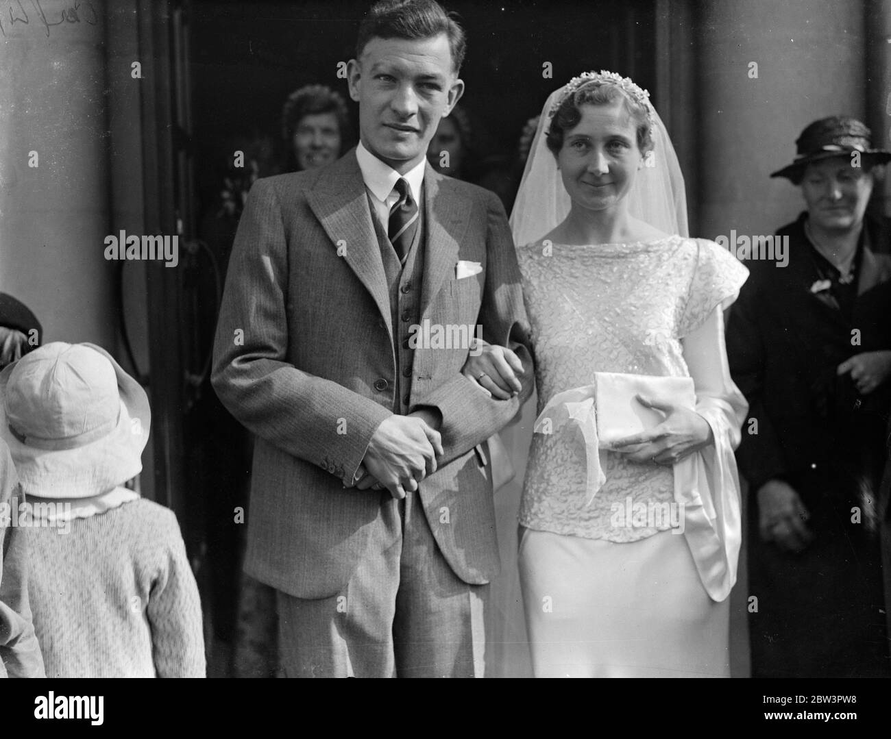 Famous athlete married at London church . K BH Yates , the track captain of the South Bound London Harriers was married to Miss M Michelmore , at ST Boniface Church , Tooting . Photo shows , the bride and groom . 8 September 1935 Stock Photo