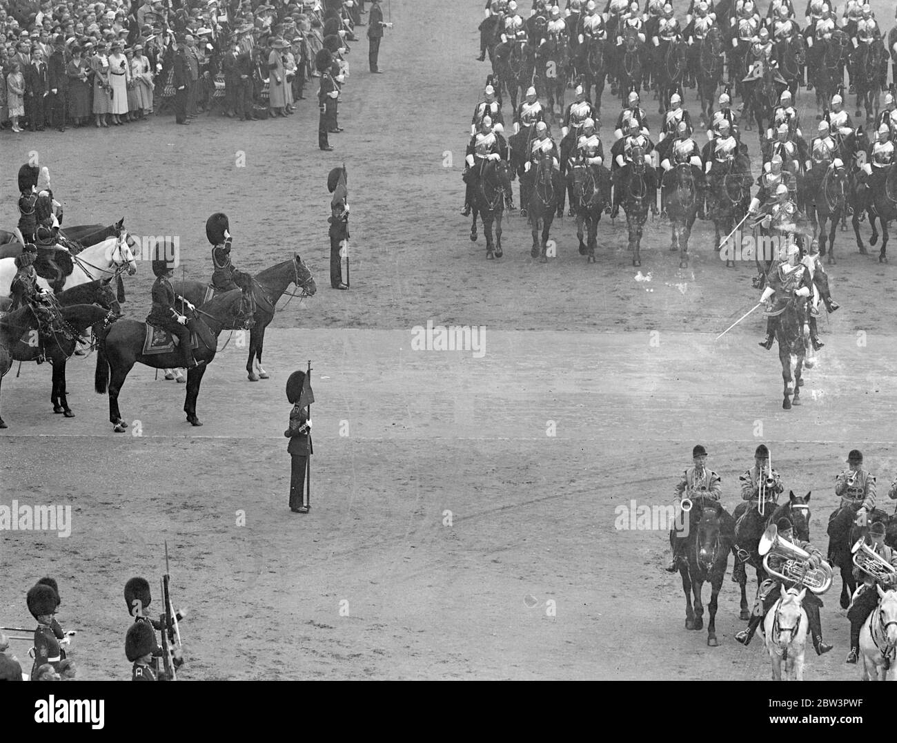 King At First Trooping Of The Colour As Monarch For the first time as monarch King Edward VIII took part in the Trooping of the Colour ceremony at the Horse Guards Parade in honour of his 42 nd birthday . His Brother the Duke of York , The Royal Dukes , the military attaches of Foreign Powers and Colonels of the Guards Regiments accompanied him om horseback . Photo Shows : The Horse Guards passing the King who is at the saluting base . 23 Jun 1936 Stock Photo