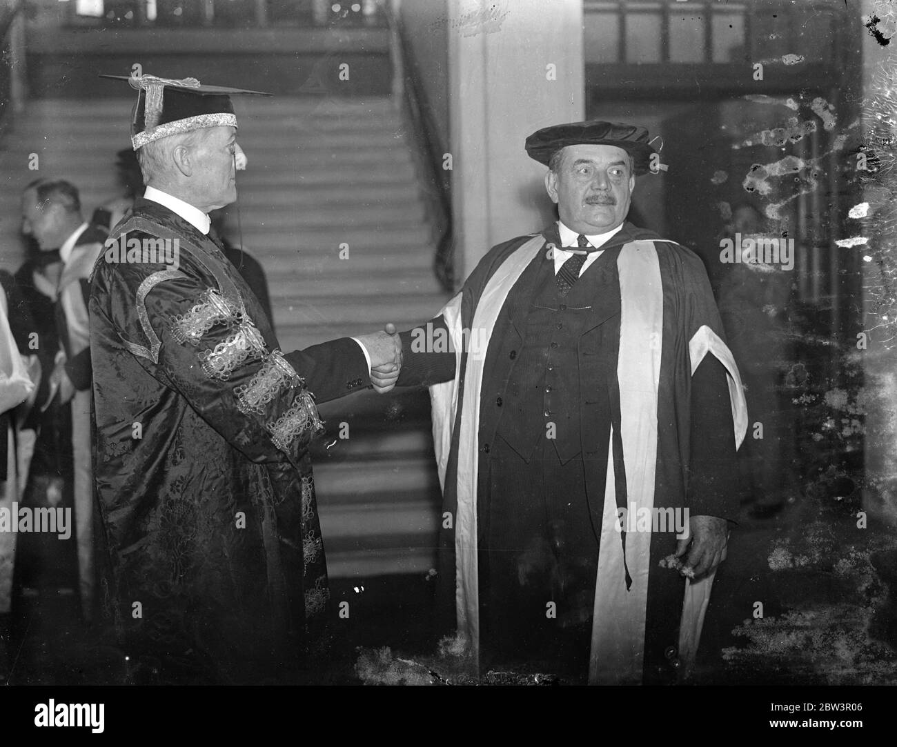 Sir Auster Chamberlain installed as Chancellor of Reading University . M Herriot recieves degree . Sir Austen Chamberlainwho was accompanied by M Herriot , Minister without Portclio in the French Cabinet and Viscout Hailshaw , the Lord Chancellor , was installed as Chancellor of Reading University . Viscount Hailsham , Sir Austen , and M Merriot received the honorary degree of Doctor of Letters . Photo shows , Sir Austen Chamberlain congratulated by M Herriot at the ceremony . 2 December 1935 Stock Photo