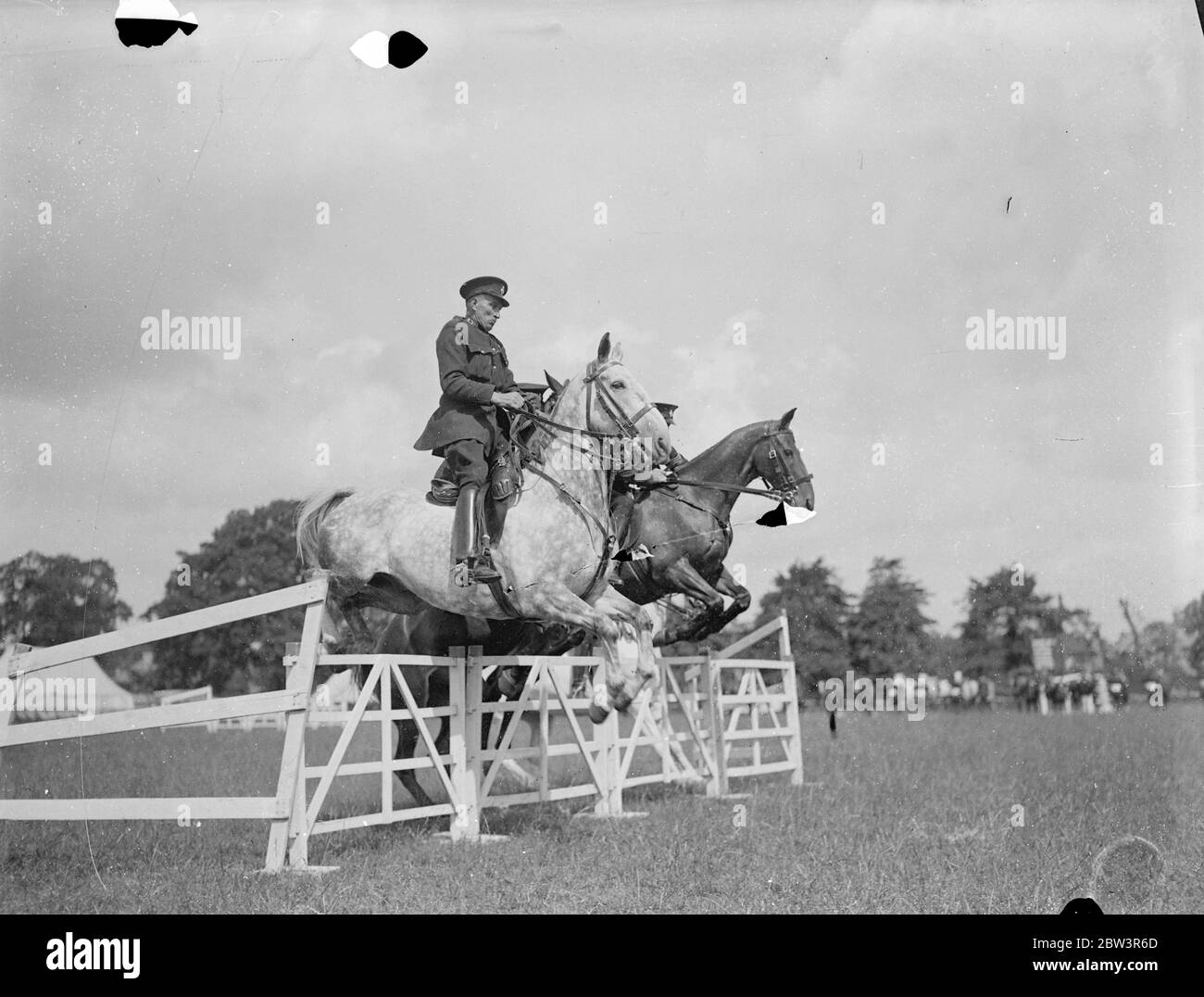 Police riders compete at Imber Court horse show . The Metropolitan Police Horse Show , in which crack police riders from all over the counrty are competing has opened at Imber Court , Twickenham , Middlesex . The show , the sixteenth , is the last at which the man who started it , Lieutenant Colonel , Sir Percy Laurie , Assistant Commisioner , attends in his official capacity , as he retires next week . Photo shows , No 1 section competing in the half section jumping . 8 July 1936 Stock Photo