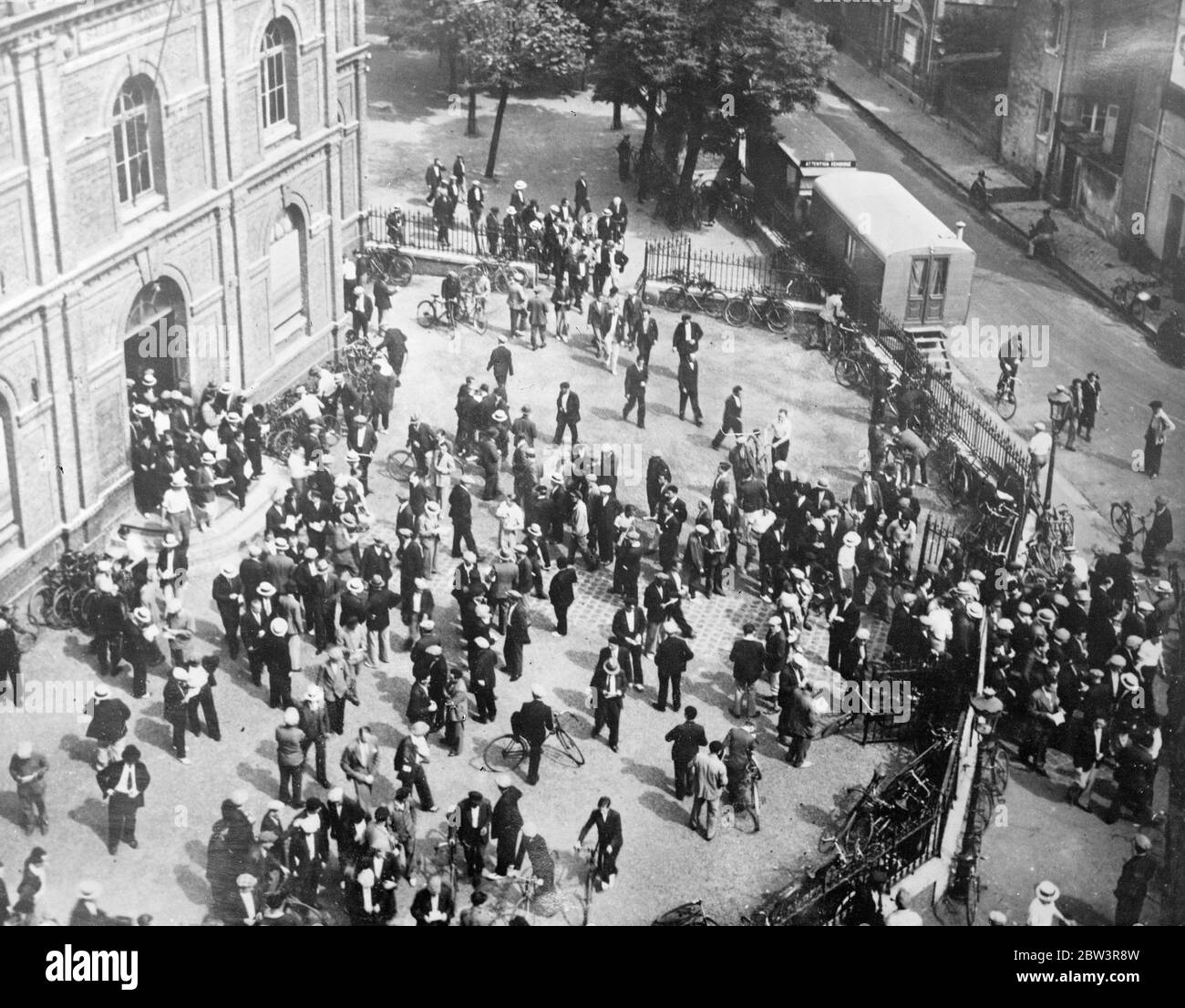 Strikers still hold up champlain . The 28 , 000 ton French liner Champlain is still held up at Le Harve by the strike declared by seamen as a protest against the pay cuts . Photo shows , strikers leaving the hall after their meeting at Le Harve . 9 August 1935 Stock Photo