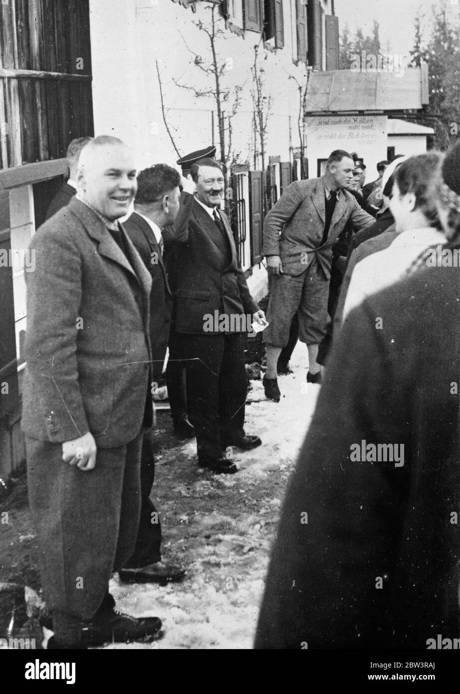 Hitler as winter sports fan . Chancellor Hitler visited Berchtesgaden in the Bavarian highlands to watch the winter sports meeting of the Nazi ' Strength through Joy ' movement . Photo shows , Hitler smilingly lifts his arm in the Nazi salute at the meeting . 31 December 1935 Stock Photo