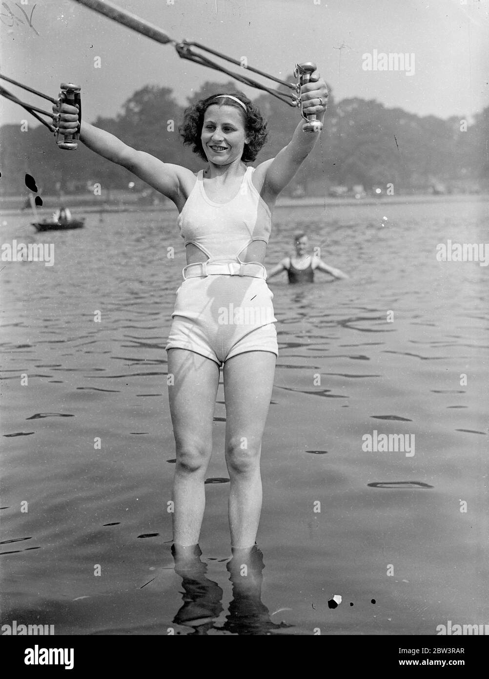 She helps the ultra violet . A girl bather at the Serpentine Lido who believes in giving the sunshine some help in providing physical fitness . 20 June 1936 Stock Photo