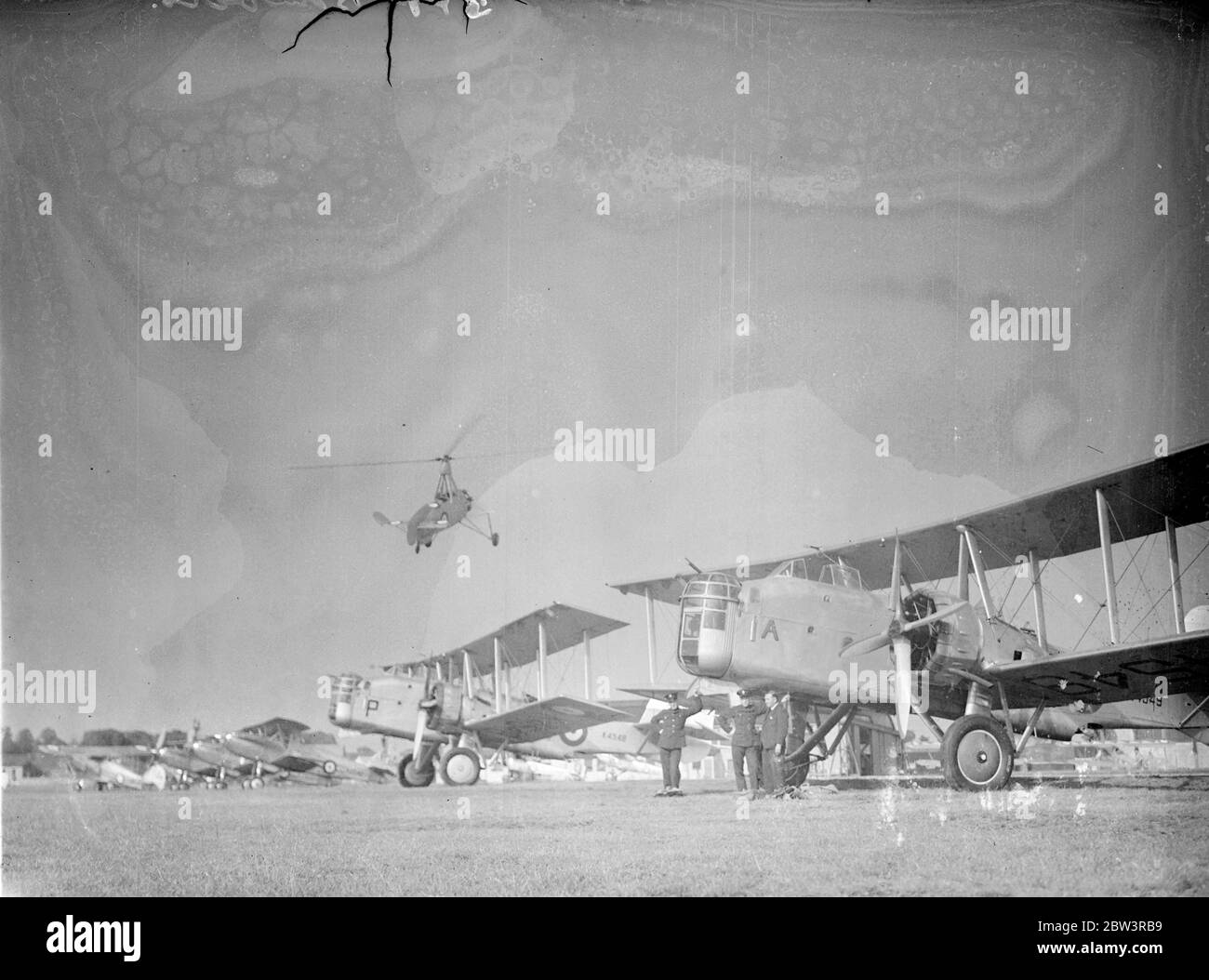 Boulton Paul P.75 Overstrand twin-engine biplane medium bombers of the Royal Air Force . Above them can be seen a Avro Rota Mk 1 Cierva Autogiro C30 A June 1936 Stock Photo