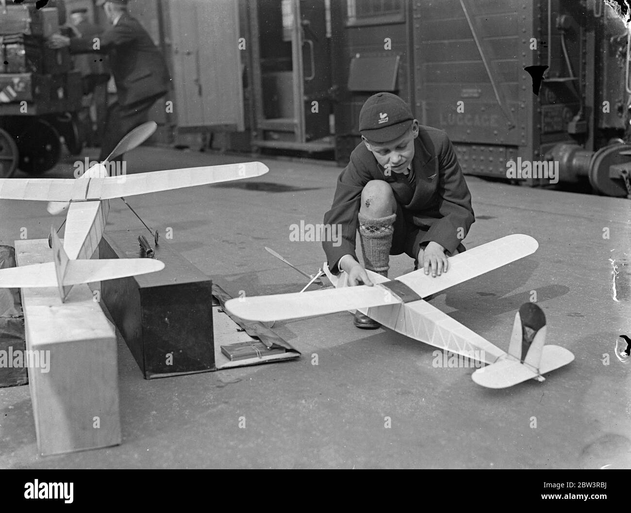 Boys leave London to compete with America in model aeroplane contest - first British team . Alan Greenhalgh , aged 13 , of Bolton , with his model plane on the platform at Waterloo , London . 20 June 1936 Stock Photo