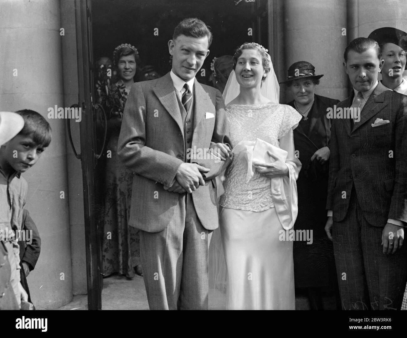 Famous athlete married at London church . K BH Yates , the track captain of the South Bound London Harriers was married to Miss M Michelmore , at ST Boniface Church , Tooting . Photo shows , the bride and groom . 8 September 1935 Stock Photo