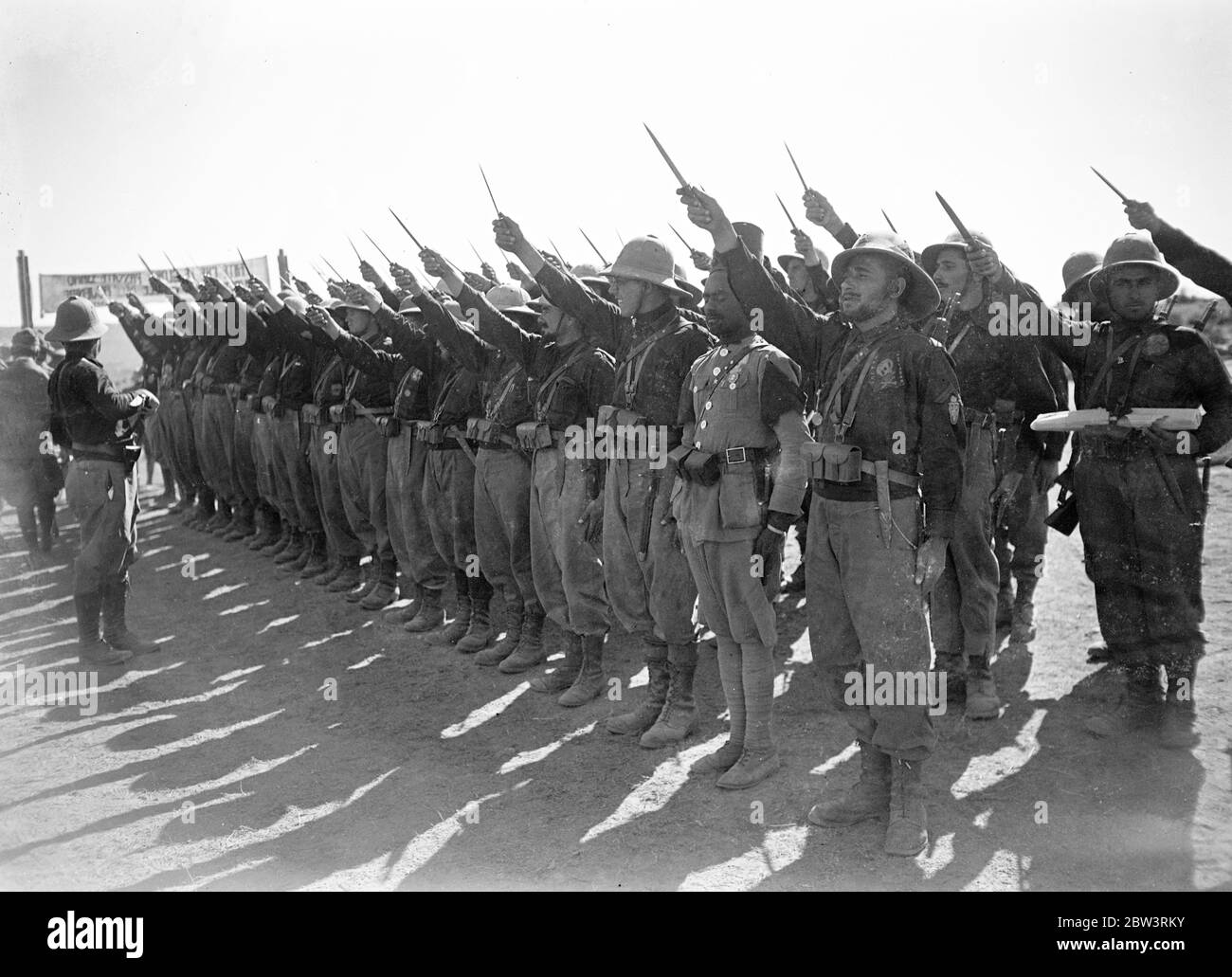 Troops giving dagger salute to General Montagna at Adigrat on anniversary of March on Rome . May 1936 Stock Photo