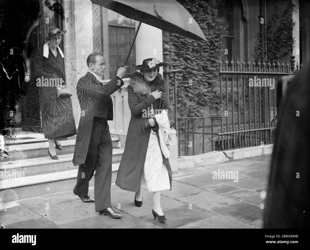 Duchess of Kent leaves Belgrave Square for Tyneside . The Duchess of Kent left 3 , Belgrave Square for her visit to Tyneside where she will launch the cruiser HMS Sheeld from the Walker Naval Yard of Vickers Armstrong Ltd . Photo shows , the Duchess of Kent leaving 3 , Belgrave Square , under an umbrella accompanied by Lady Mary Hope , her Lady in Law who is to marry Lord Herbert next Monday . 23 July 1936 Stock Photo