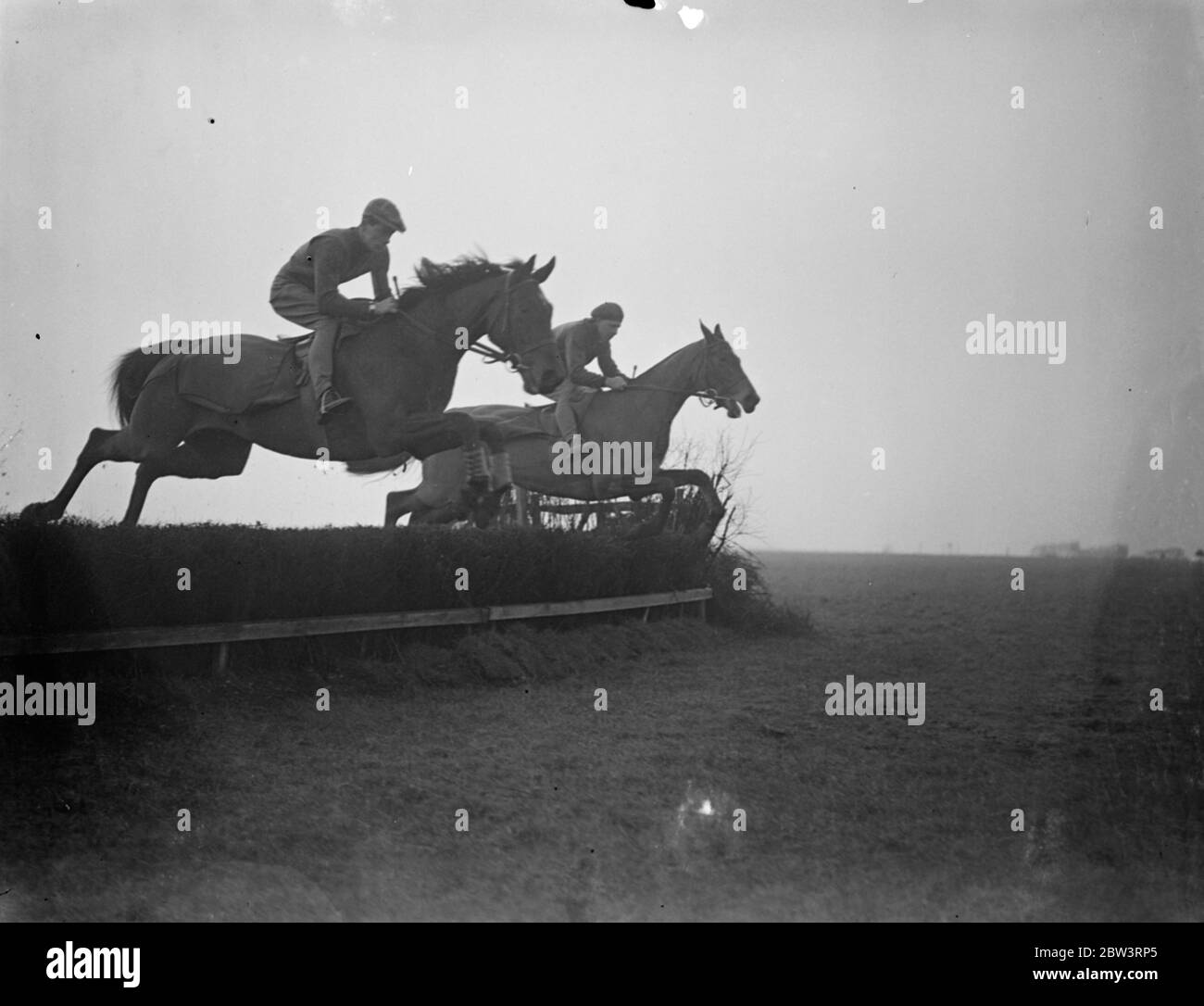 Golden Miller and his new jockey make acquaintance in gallops and jumps . Evan Williams , Golden Miller ' s new jockey made his first acquaintance with the horse when he rode him in gallops and jumps at Owen Anthony ' s training quarters at Letcombe Bassett , Wantage , Berkshire . Golden Millerk owned by Miss Dorothy Paget , the millionaire racehorse owner , lost his place as favourite for the Grand National when he refused to take a jump at Newbury Steeplechase . Photo shows Golden Miller ( nearest camera ) with William up , taking a fence with Richard a stable companion . 4 March 1936 Stock Photo