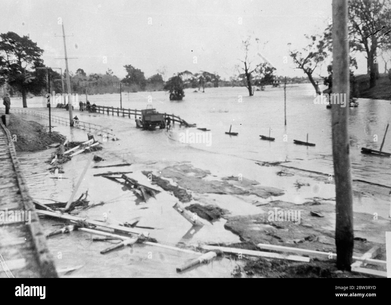 Many Feared Drowned , Hundreds Homeless In Australian Floods . Roads And Bridges Wrecked . Roads , bridges and all other communications broke down near Bairnsdale in the Eastern Gippsland district of Victoria , Australia , as the result of serious floods . Hundreds of families lost their homes and thousands of cattle died . Many people were forced to seek safety on the roofs of buildings and 23 persons were rescued from the roof of one house near Bairnsdale . Police feared , however , that numbers of farmers and members of their families had been trapped and drowned . The floods were caused by Stock Photo