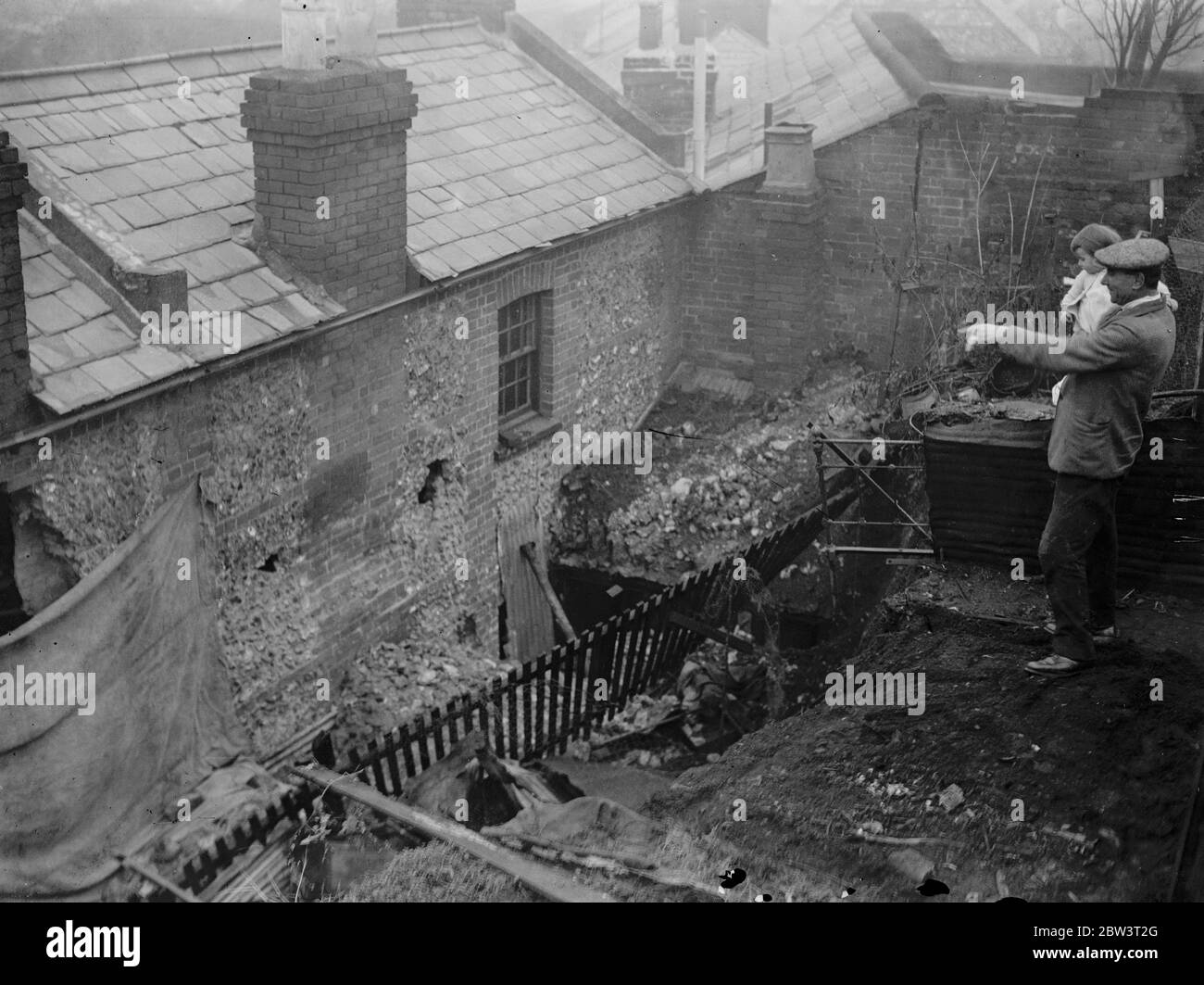 Eight escape when 40 ton wall crashes on two houses at Henley . November 1935 Stock Photo