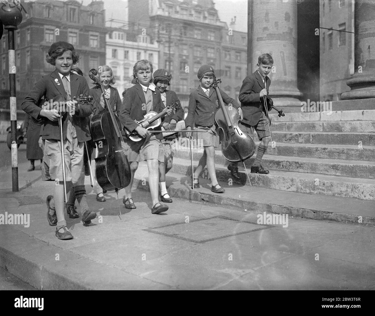 London ' s Musical Children Play At The Queen ' s Hall . Hundreds of young musicians are taking part in the School Orchestra and Junior Band Festival at Queen ' s Hall , London . Photo shows : Childrens arriving with their instruments . 16 May 1936 Stock Photo