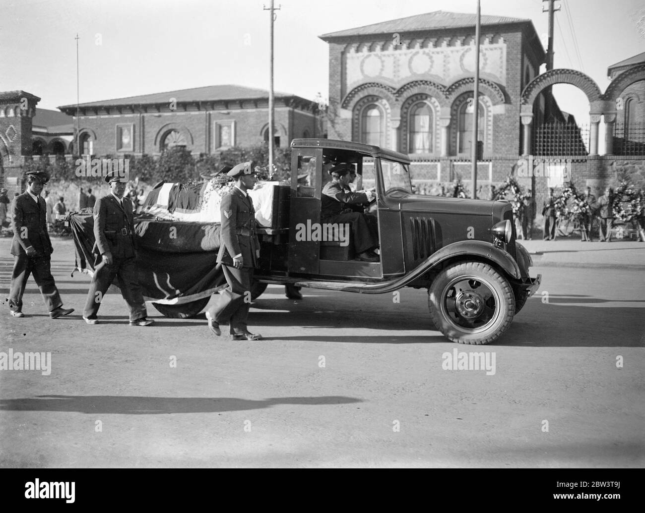 First airman killed in Abyssinian war given military funeral . The first airman killed in the Abyssinian war , Sergeant Birngo Dalmazio , a 24 year old flight sergeant and mechanic of the Italian forces who was wounded while on a bombing raid , was buried with full military honours in Asmara . Dalmazio , , who was hit by a dum dum bullet while flying with Lieutenant Sanze on a bombing raid on a decoy native camp in the valley between Enda Micael and Buja , was taken to hospital at Asmara but died from his wounds . Photo shows , the body passing through the streets of Asmara . 28 November 1935 Stock Photo