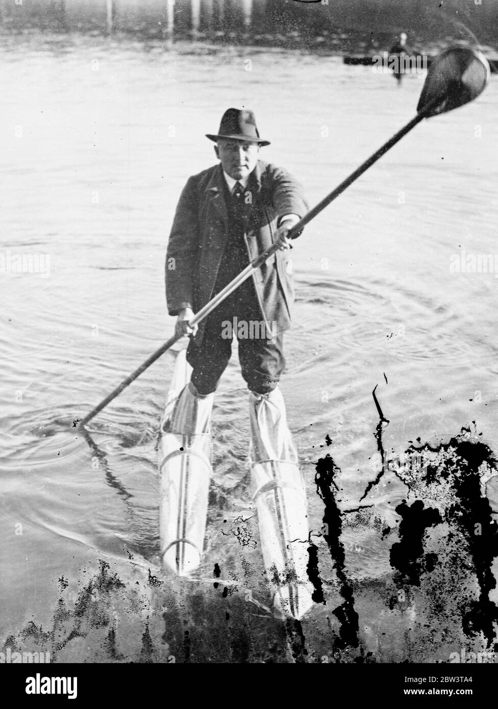 German invents metal water skis . Covers 15 miles in four hours . Herr Neumann demonstrating his new water skis . 16 October 1935 Stock Photo