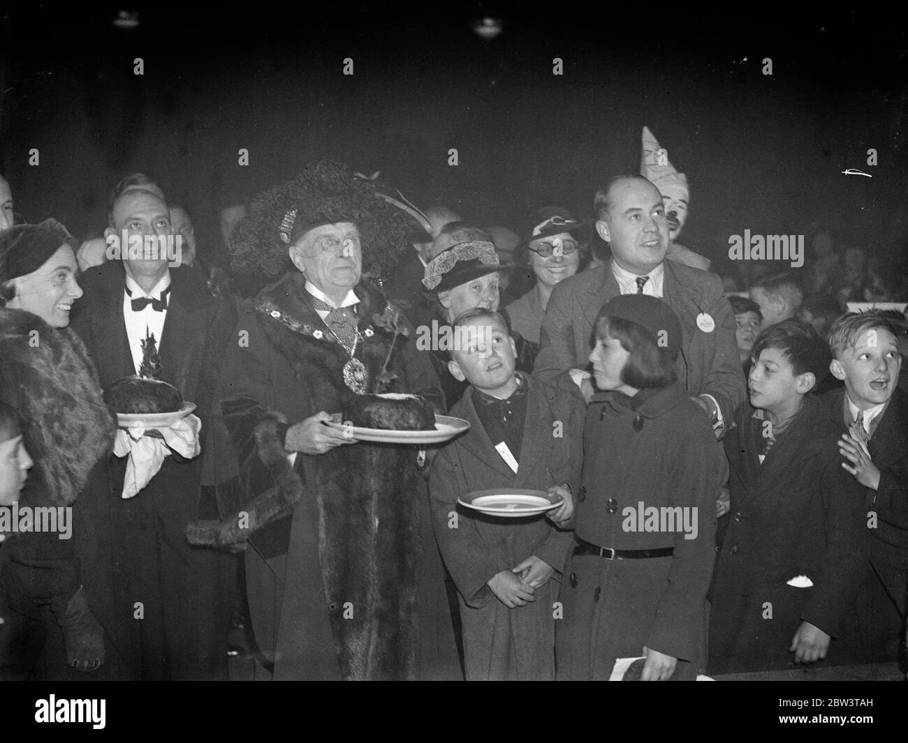 Lord Mayor serves Christmas pudding at poor children 's party at Guildhall . The Lord Mayor , Sir Percy Vincent , serving the Christmas pudding at the banquet . 23 December 1935 Stock Photo
