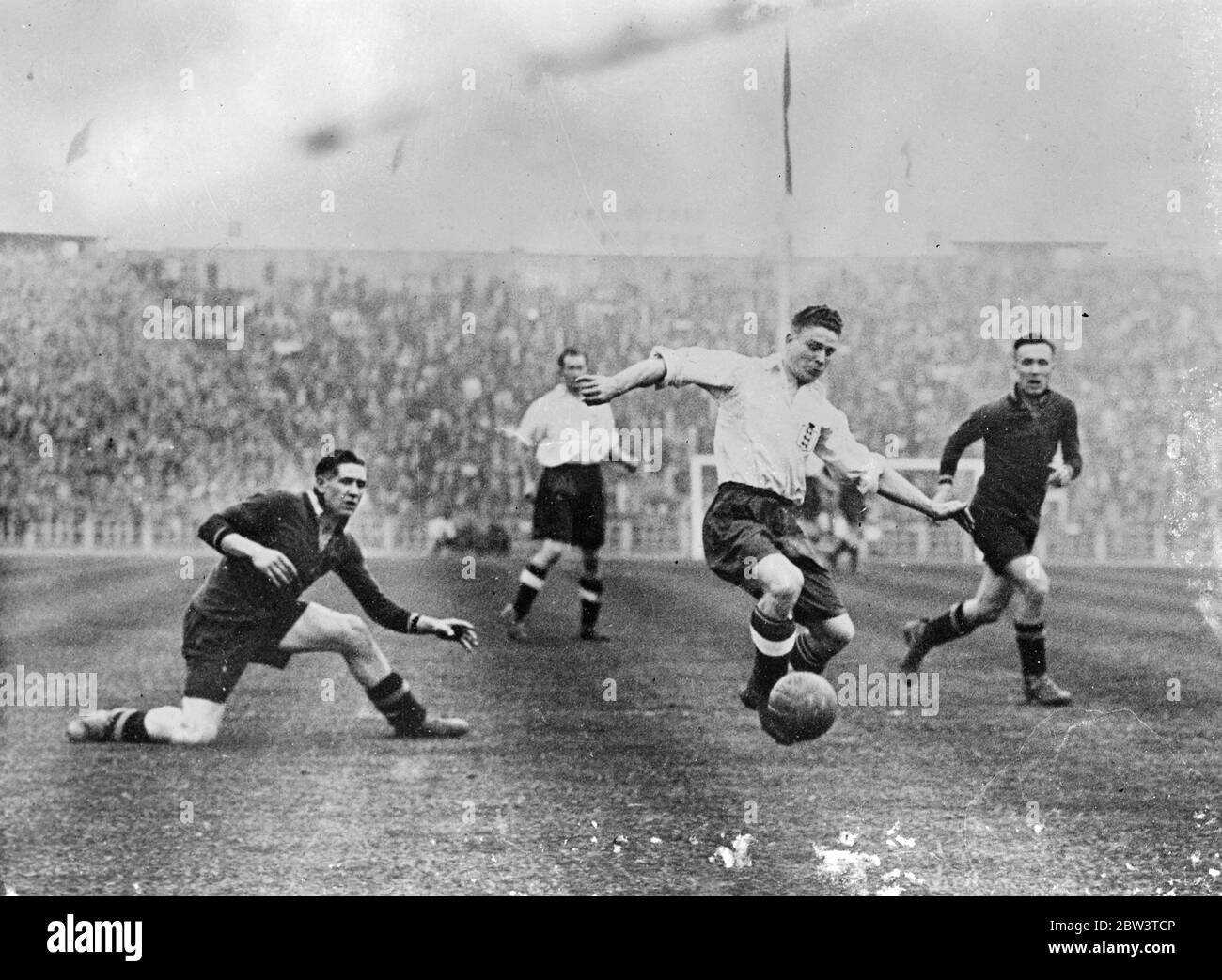 Belgium deals another soccer blow at England . Fresh from its defeat at the hands of Austria , the England football team had again to lower its colours in Brussels , where it was beaten by Belgium 3 , 2 . Photo shows an attack on the Belgium goal by George Camsell the England centre forward . 11 May 1936 Stock Photo