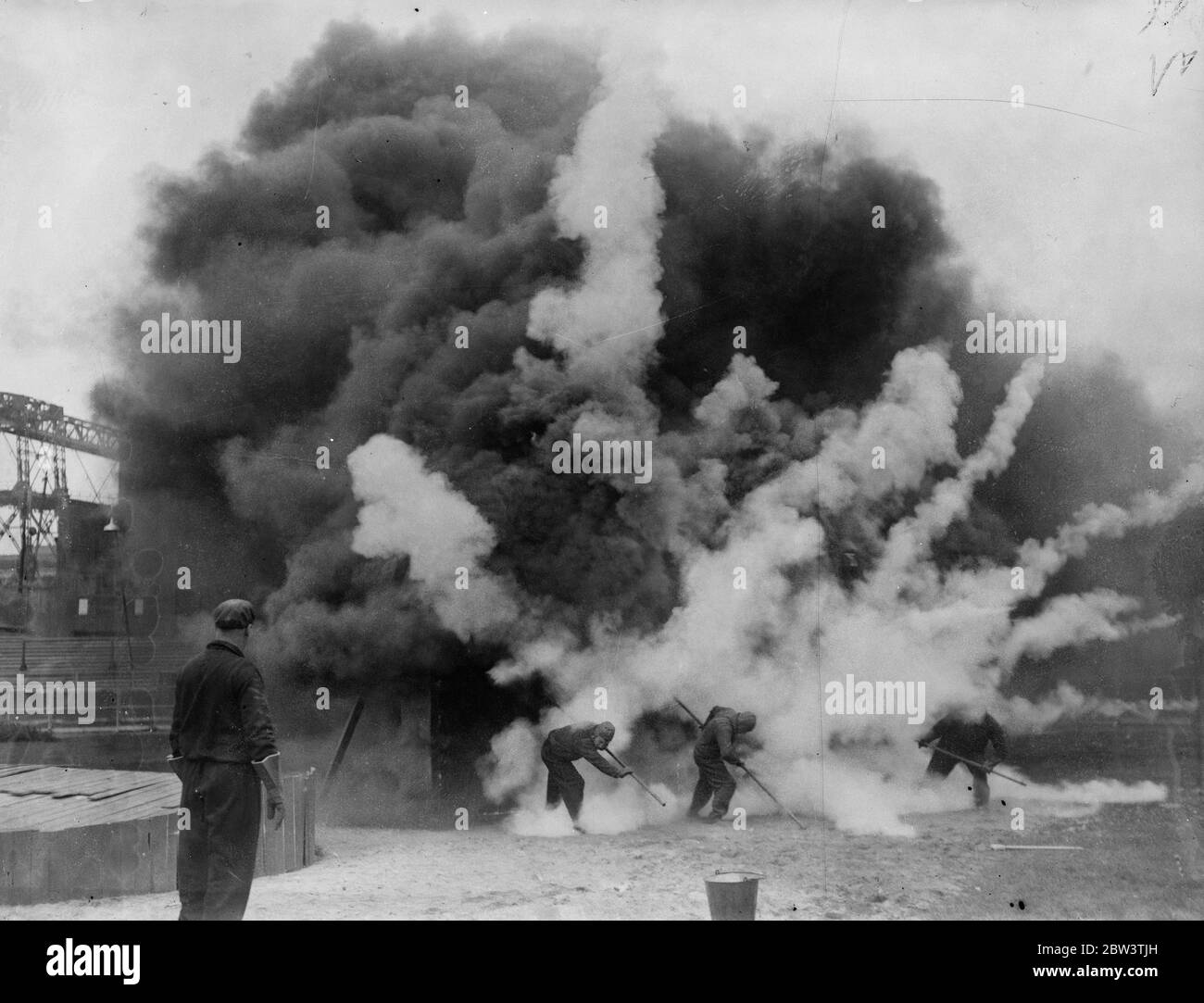 A bomb that puts out fires demonstrated at Clapton Stadium . A blazing building at the demonstration . 16 September 1935 Stock Photo