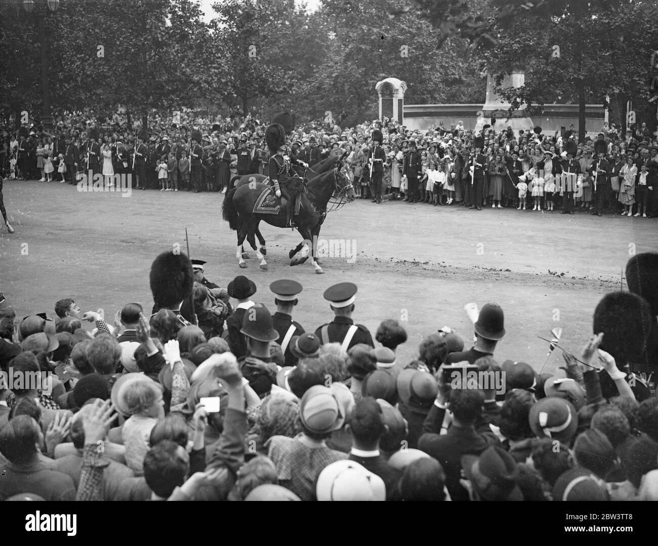 King At First Trooping Of The Colour As Monarch For the first time as monarch King Edward VIII took part in the Trooping of the Colour ceremony at the Horse Guards Parade in honour of his 42 nd birthday . His Brother the Duke of York , The Royal Dukes , the military attaches of Foreign Powers and Colonels of the Guards Regiments accompanied him om horseback . Photo Shows : The King leading the procession along the Mall to the Horse Guards . 23 Jun 1936 Stock Photo