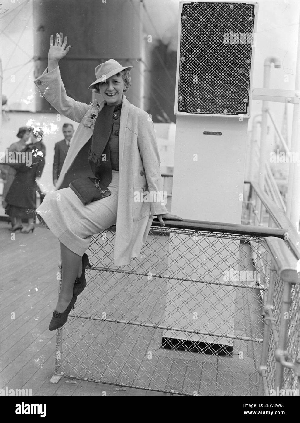 Cora Goffin , the well - known British comedy actress , waves to the camera onboard ship . Stock Photo
