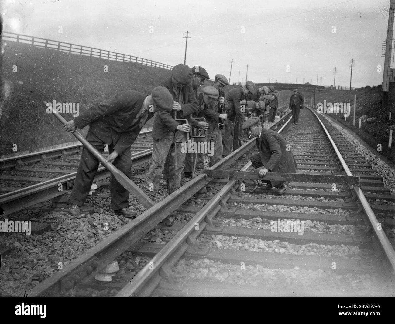 Five hundred men relay 80 miles of rail in four days as LNER make big change over Tyneside . Five hundred men are engaged near Newcastle on one of the most complex high speed enginearing jobs carried out in Britain for some time . Eighty miles of steel conductor rail is being taken up and relaid in four days . To conform with modern standards the conductor rail throughout the whole length of the LNER electrified lines on Tyneside is being taken up and moved 3 1 / 4 inches nearer the running rail . Fifty thousand insulators have to be removed and the whole of the continuity track cables require Stock Photo