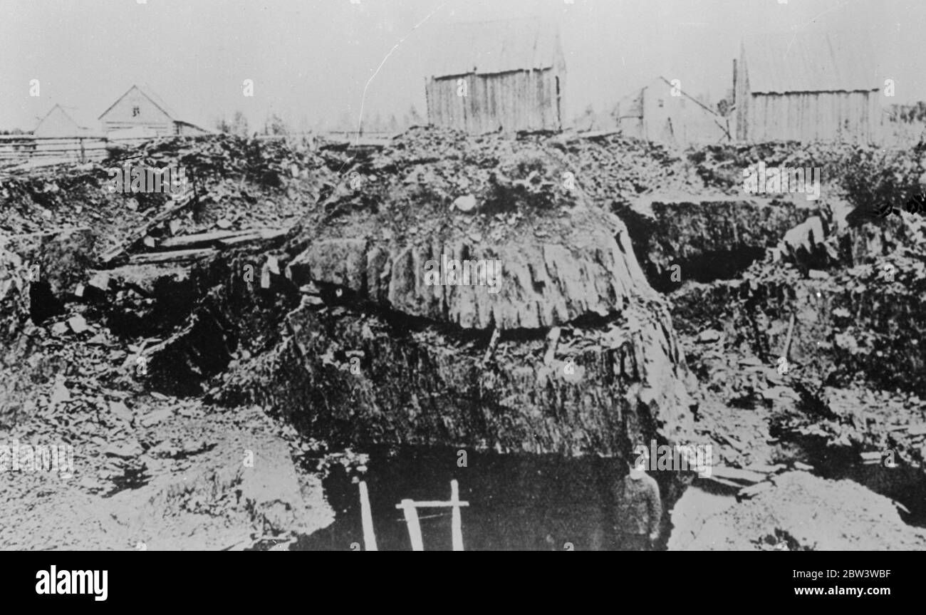 New picture of entomed men . Ten days in Moose river gold mine . Few hours from life . Entombed for ten days , Dr D E Robertson and Charles Alfred Scadding , the two men trapped in a gold mine at Moose River , Nova Scotia , are now seperated by 12 feet of solid rock from the workers who are labouring night and day to rescue them . Time after time rescue workers have been prevented in their fight by fresh falls and insurmountable obstacles . Now they have to cut off at a slant to escape the solid wall of rock that alone keeps them from the trapped men . Food poured through a drill driven throug Stock Photo