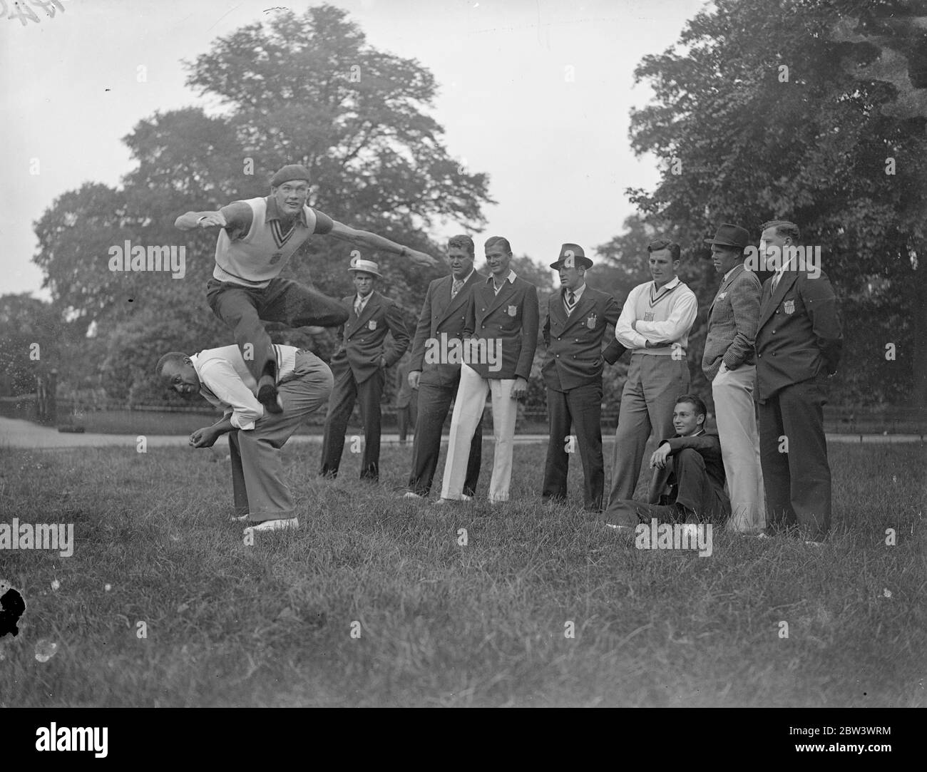 Jesse Owens makes a back . American Olympic team in London for USA British Empire athletics . Members of the American Olympic team , fresh from their triumphs in Berlin , loosened up during a walk in Hyde Park for the match with British Empire athlete at the White City tomorrow ( Saturday ) . Photo shows , Jesse Owens , the fastest human who won three Olympic gold medals , makes a for W towns , the hurdler in Hyde Park . 14 August 1936 Stock Photo