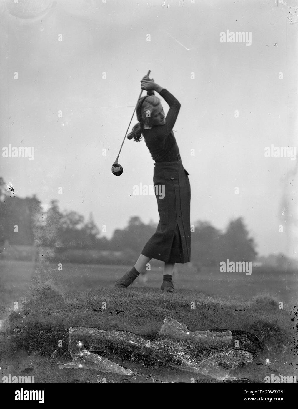 Girls open golf championship at Stoke Poges . The opening matches in the Girls Open golf championship are being played at Stoke Poges . Britian ' s leading girl players are being challenged by two French competitors Lally and Sonia Vagliano , and one South African , Miss Daphne Martyn from Port Elizabeth . Photo shows , Miss Angela Noble arriving on the course . 9 September 1936 Original caption from negative Stock Photo