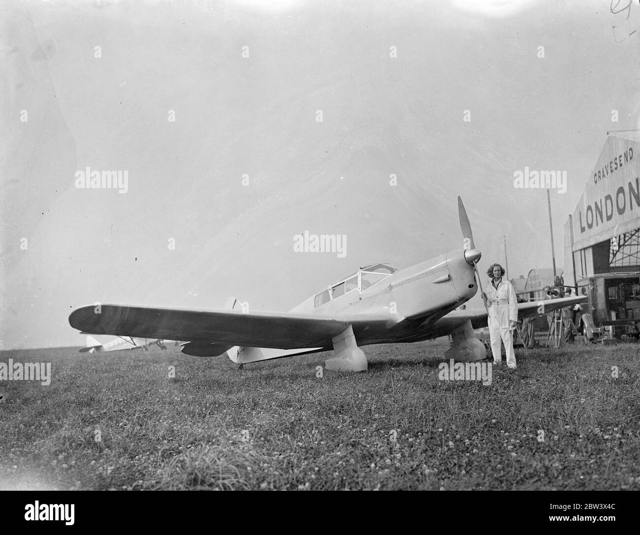 Society mother prepares near London for Long East - West Atlantic flight . Mrs Beryl Markham , 31 year old mother of a boy of seven and sister in law of Sir Charles Markham , the colliery baronet , is preparing at an aerodrome near London for her attempt to fly non stop from London to New York alone . She is using a Vega Gull plane fitted with long range tanks sufficient to cover about 3 , 800 miles at a cruising speed of more than 150 miles an hour . Mrs Markham , who has done more than 2 , 000 hours of flying , has spent months planning the flights with experts . Photo shows , Mrs Beryl Mark Stock Photo